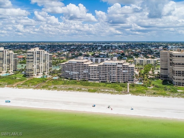 birds eye view of property with a beach view and a water view