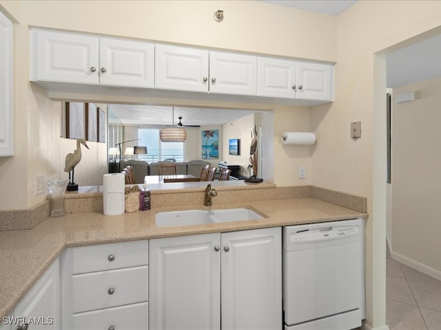 kitchen with white cabinets, light tile patterned floors, sink, and dishwasher