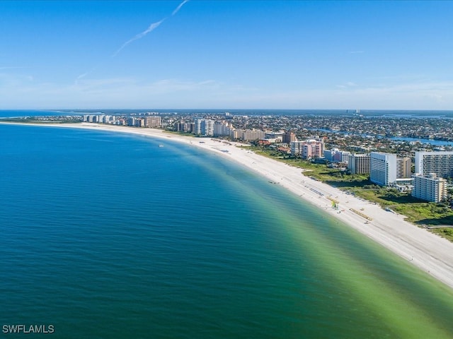 birds eye view of property with a view of the beach and a water view