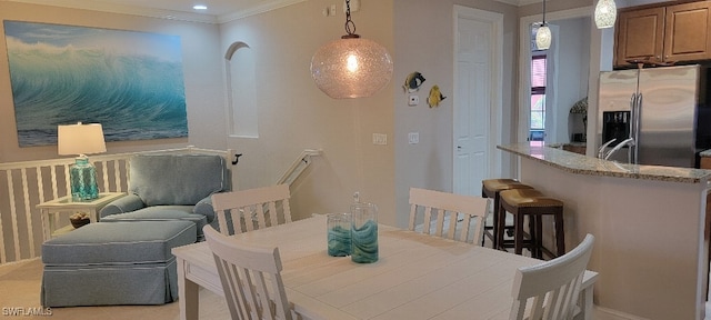 dining space with ornamental molding