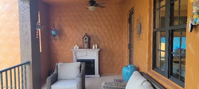 sitting room featuring ceiling fan