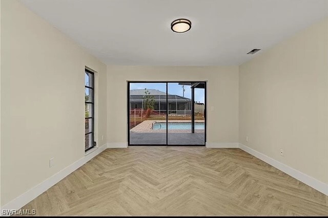 spare room with light parquet flooring