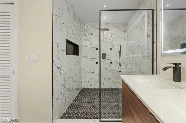 bathroom with vanity and an enclosed shower