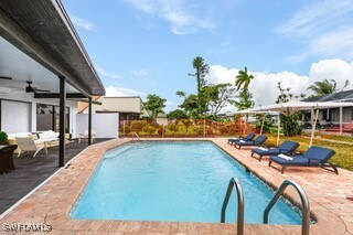 view of pool featuring ceiling fan and a patio