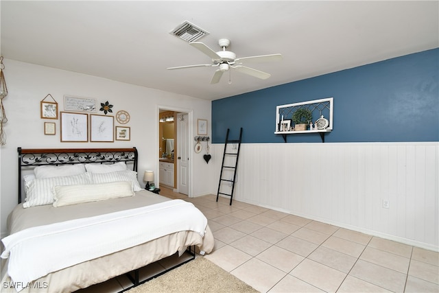 tiled bedroom with connected bathroom and ceiling fan