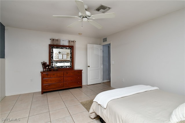 tiled bedroom featuring ceiling fan