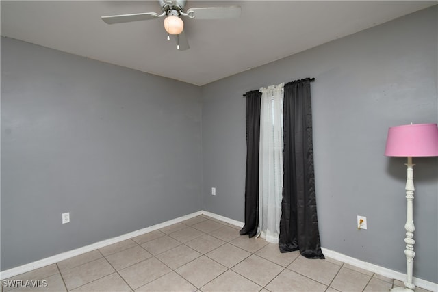 spare room featuring ceiling fan and light tile patterned flooring