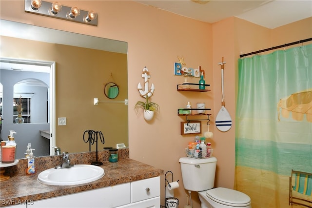 bathroom featuring vanity, a shower with curtain, and toilet