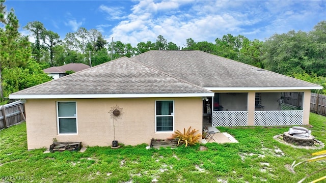 rear view of house with a lawn