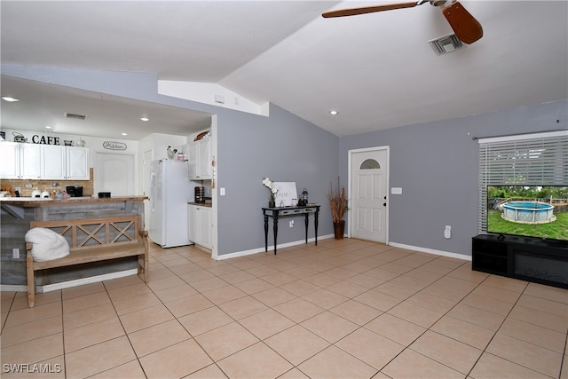 tiled foyer entrance with lofted ceiling and ceiling fan