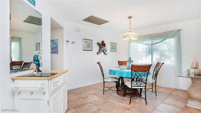 dining area with an inviting chandelier