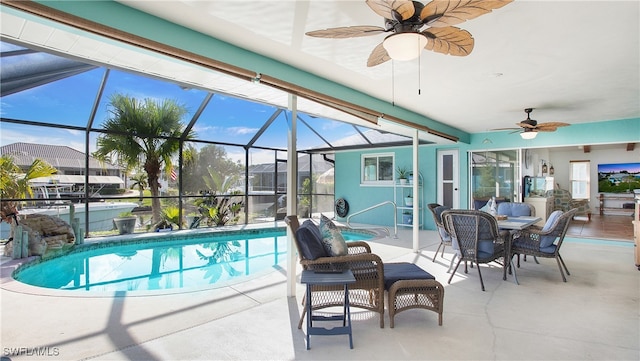 view of pool featuring a lanai, ceiling fan, and a patio