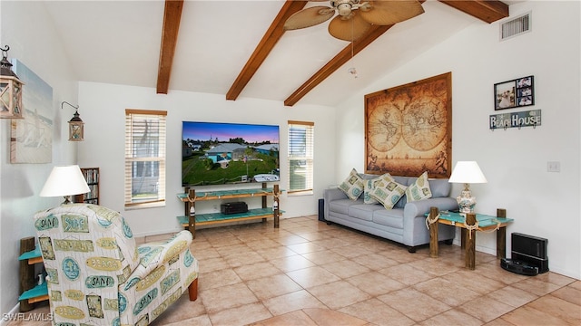 living room featuring vaulted ceiling with beams, ceiling fan, light tile patterned floors, and a healthy amount of sunlight