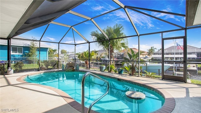 view of pool with glass enclosure and a patio area