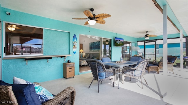 sunroom / solarium featuring ceiling fan