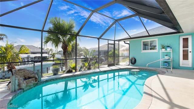 view of pool featuring a patio and glass enclosure