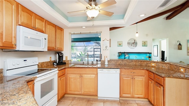 kitchen with ceiling fan, sink, stone countertops, white appliances, and a tray ceiling