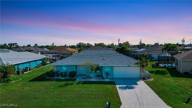 view of front facade with a garage and a yard