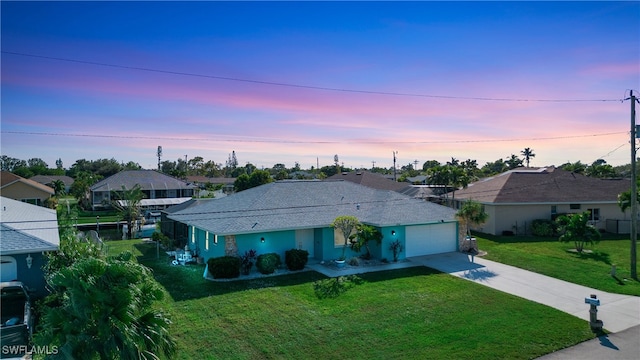 single story home with a lawn and a garage