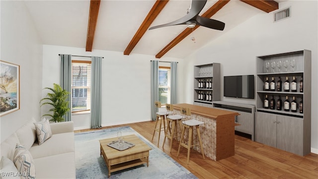 living room featuring a wealth of natural light, light hardwood / wood-style floors, and bar