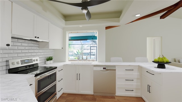 kitchen featuring dishwasher, electric stove, kitchen peninsula, light wood-type flooring, and white cabinetry