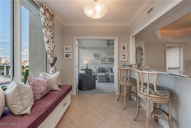 interior space featuring ornamental molding and light tile patterned flooring