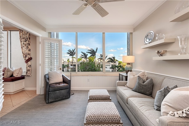 tiled living room featuring ceiling fan and ornamental molding