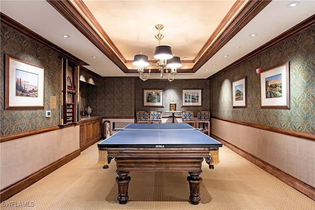 rec room featuring crown molding, light colored carpet, a raised ceiling, and an inviting chandelier