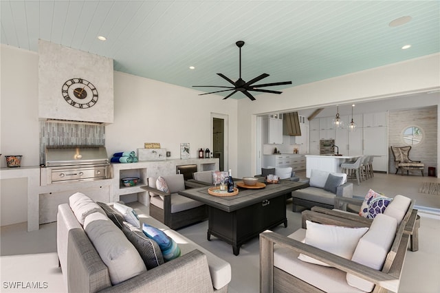 living room with ceiling fan and wood ceiling