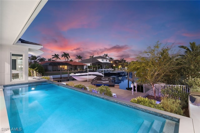 pool at dusk with a boat dock