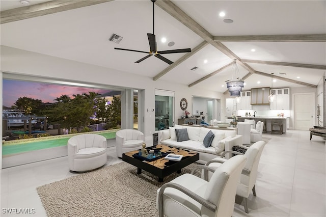 living room featuring lofted ceiling with beams and ceiling fan with notable chandelier