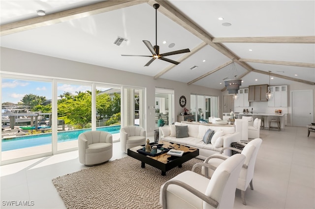 tiled living room featuring beam ceiling, high vaulted ceiling, and ceiling fan