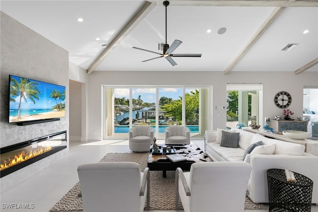 living room featuring vaulted ceiling with beams, ceiling fan, and a large fireplace