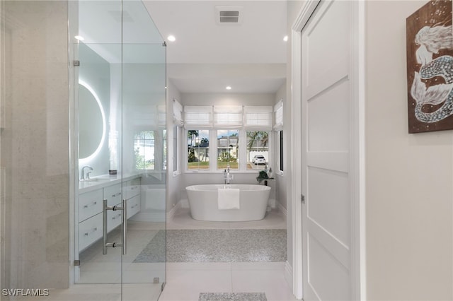 bathroom with tile patterned flooring, vanity, and shower with separate bathtub