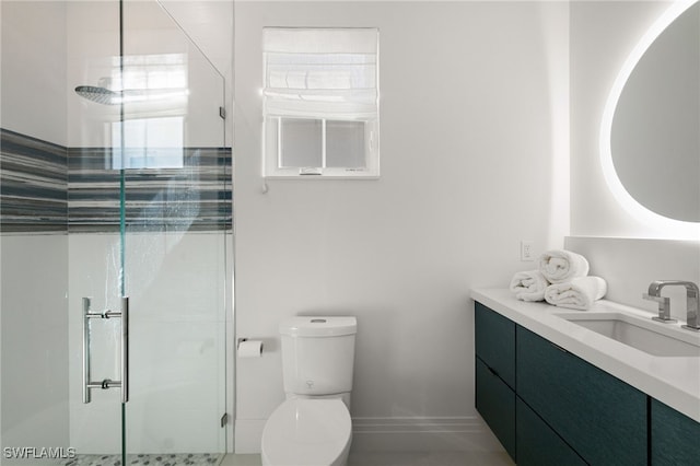 bathroom featuring vanity, toilet, and walk in shower