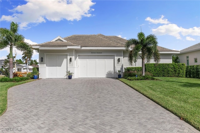 ranch-style home with a front lawn and a garage