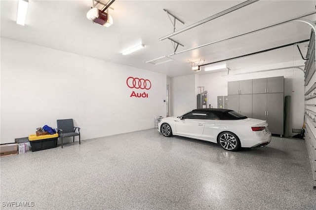 garage with electric panel, a garage door opener, and water heater