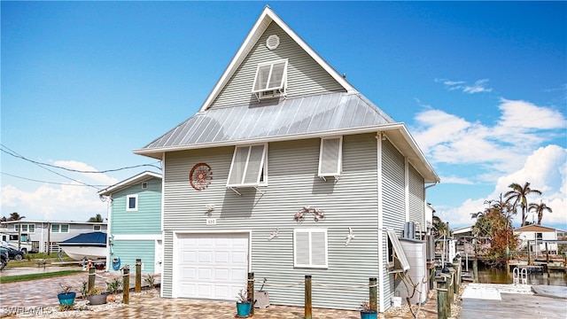 exterior space featuring a water view and a garage