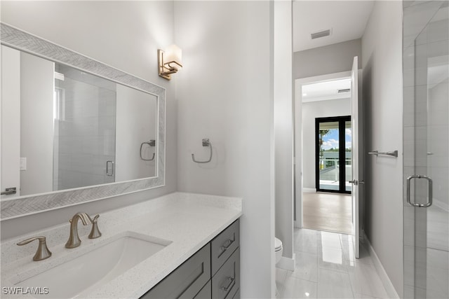 bathroom featuring vanity, french doors, a shower with shower door, and toilet