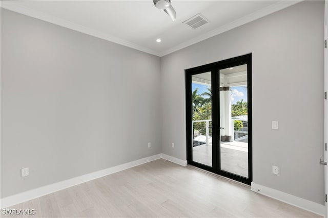 spare room with ornamental molding and light wood-type flooring