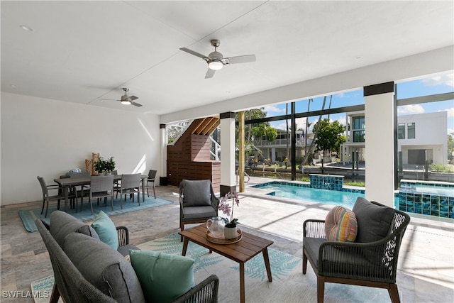 view of patio featuring a lanai, an outdoor hangout area, and ceiling fan