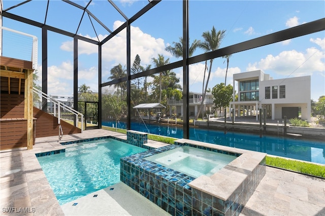 view of swimming pool with an in ground hot tub, a patio, and a lanai