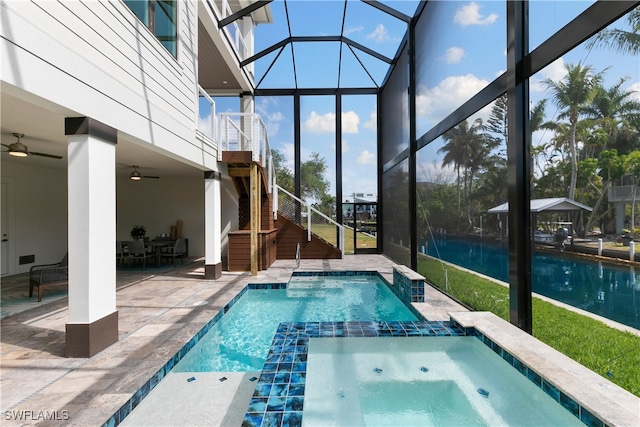 view of pool featuring an in ground hot tub, ceiling fan, a lanai, and a patio