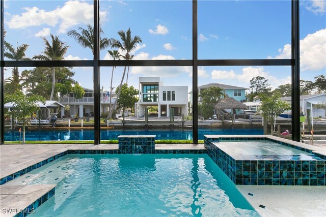 view of swimming pool featuring an in ground hot tub