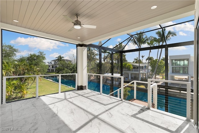 unfurnished sunroom with wood ceiling and ceiling fan