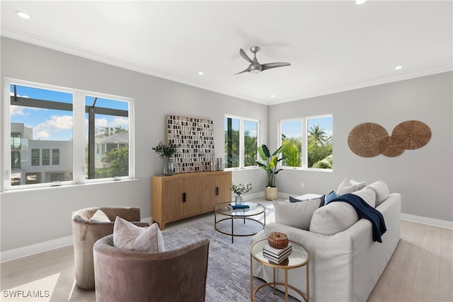 living room with crown molding, light wood-type flooring, and ceiling fan