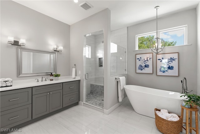 bathroom with vanity, separate shower and tub, and a notable chandelier