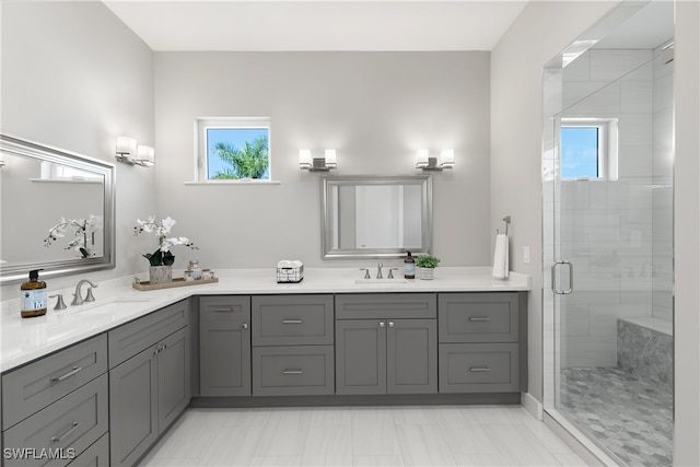 bathroom with vanity and a shower with shower door