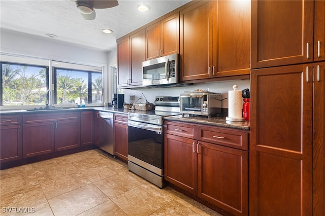 kitchen featuring stainless steel appliances, a textured ceiling, sink, ceiling fan, and light tile patterned flooring