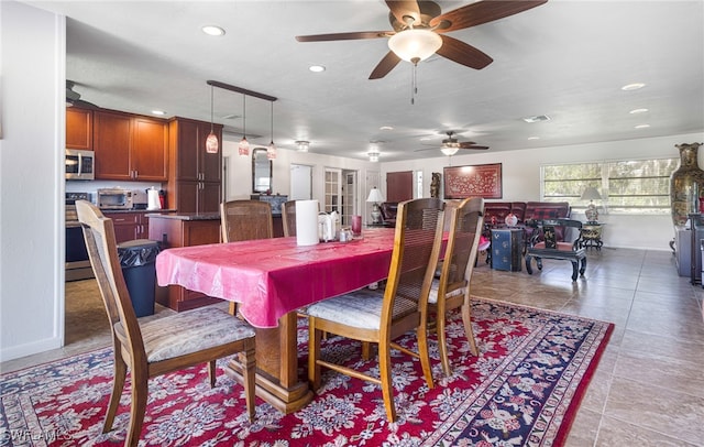 tiled dining area with ceiling fan